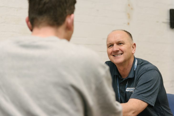 Message prisons worker talking to an inmate