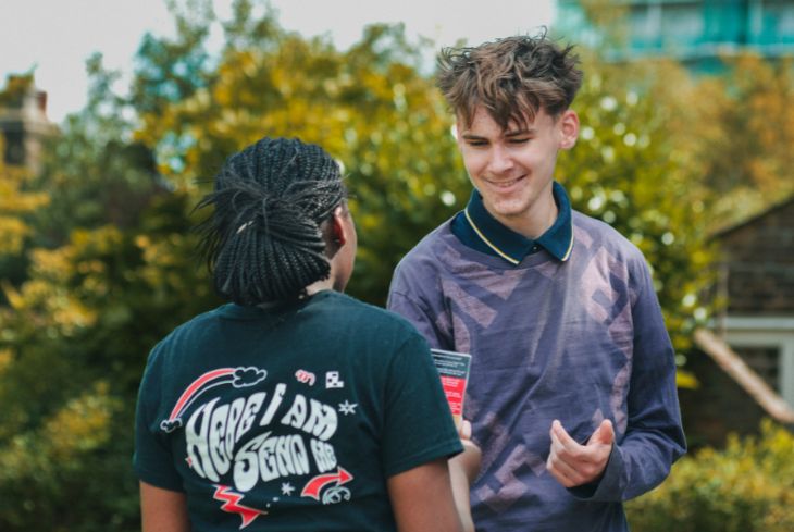 Young person wearing a t-shirt that says Here I Am Send Me