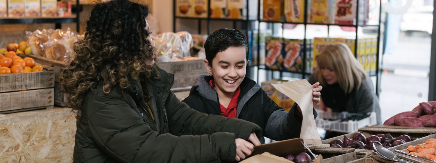 Mother and son happily shopping in Sharston Community Grocery