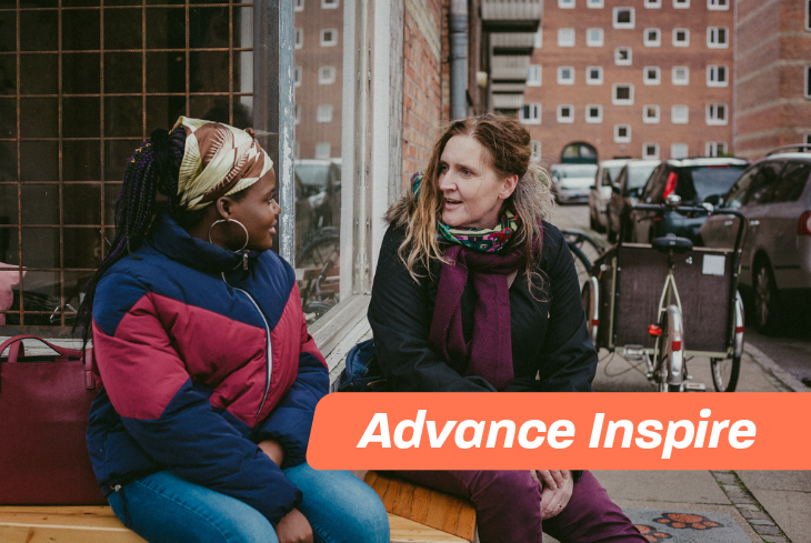 Two women speaking in a city environment
