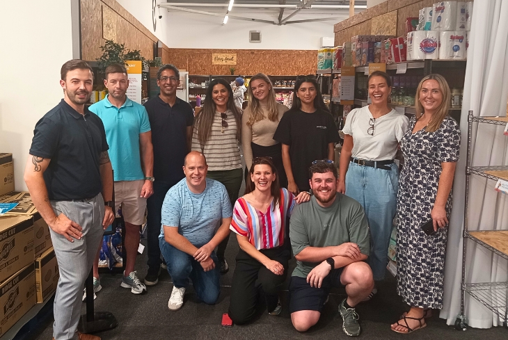 Group of people smiling in the entrance to the Community Grocery