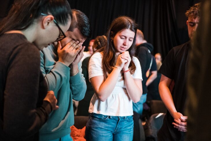Young people praying at a youth prayer gathering