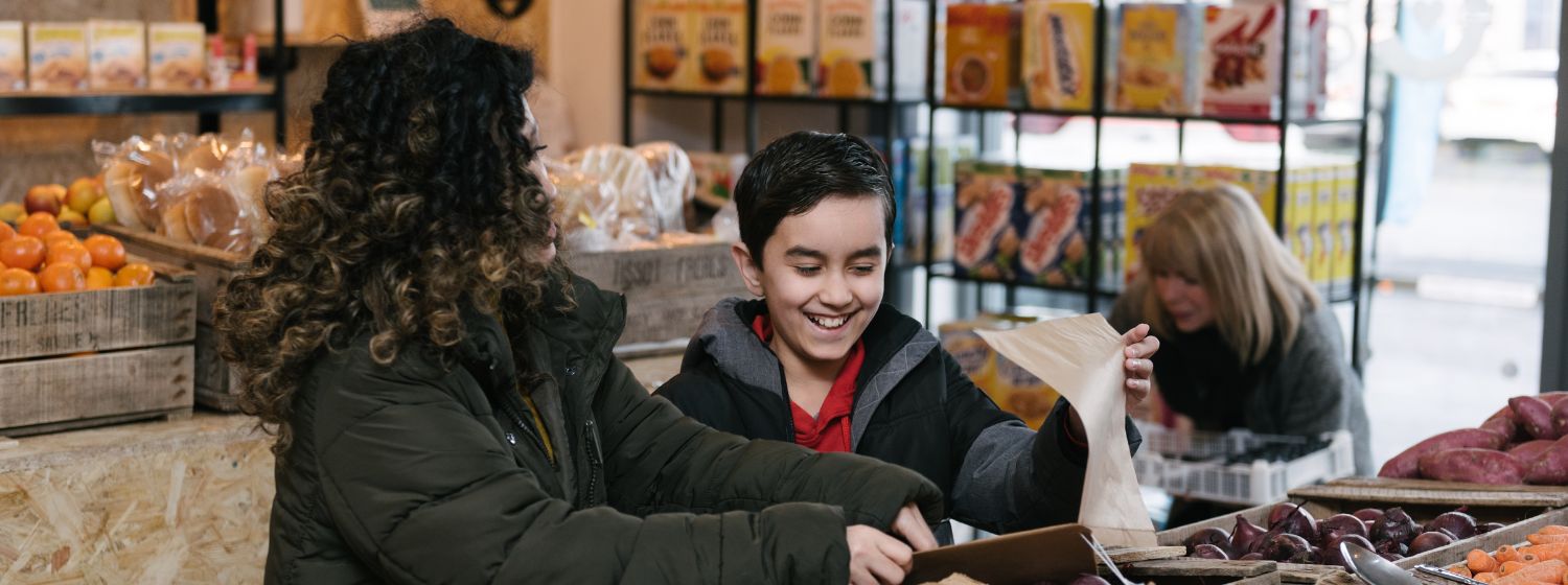 Mother and son shopping at a Community Grocery