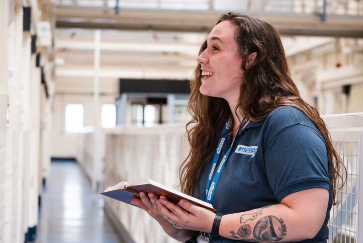 Message prisons worker reading a bible in prison