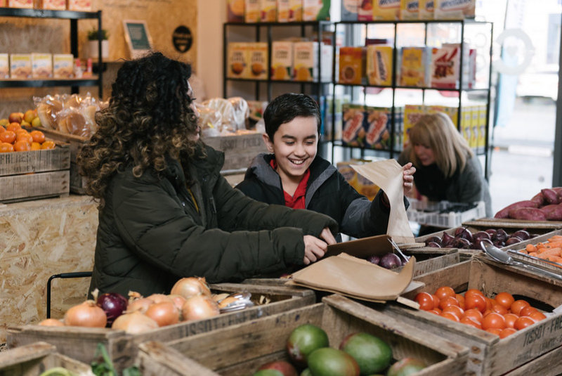 Mother and son shopping at Sharston Community Grocery
