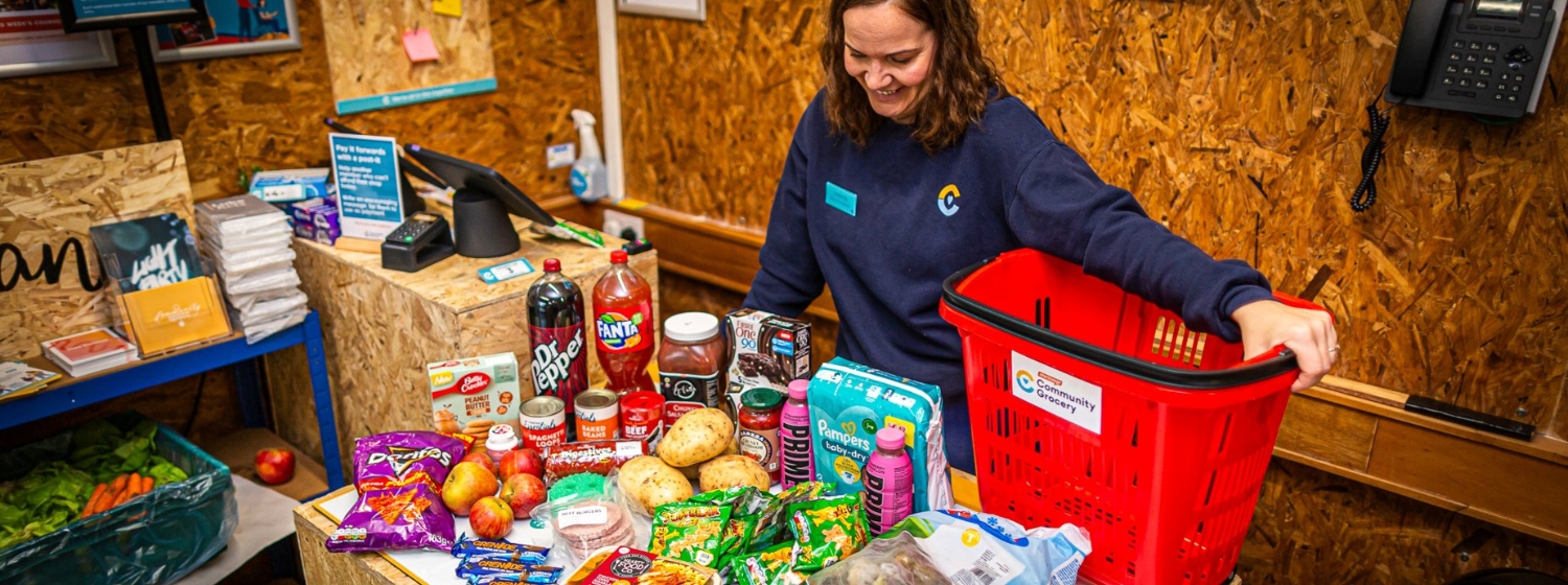 A Community Grocery manager with the food you can get in a shop as a member