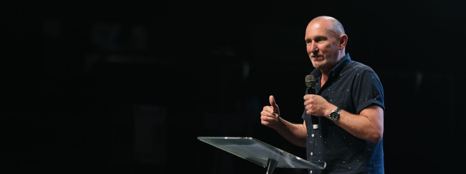 Andy Hawthorne teaching on stage.